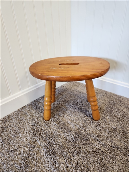 Small wooden stool with hole for handle