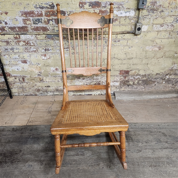 Oak cane rocking chair with metal detailing