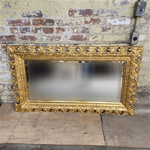 Ornately carved wooden mirror, painted gold